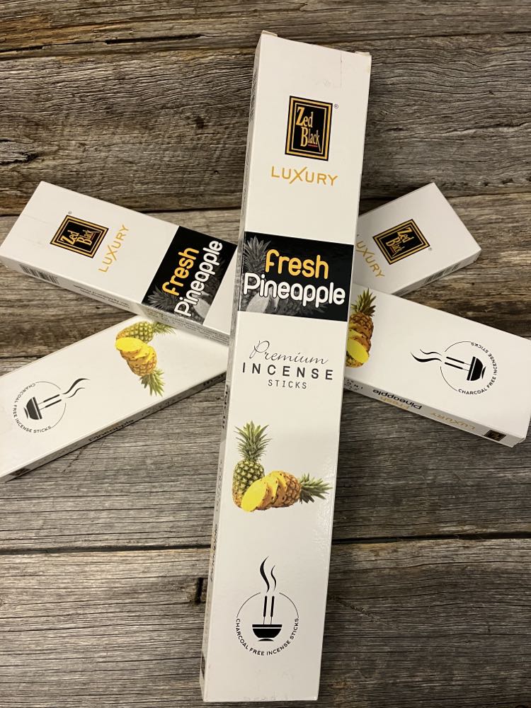 fresh pineapple incense on wood rustic display