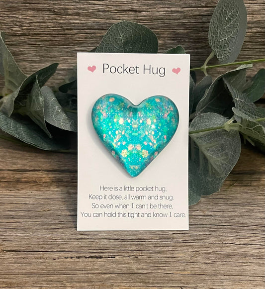 green pocket heart gift idea on wood rustic background perched on green leaves 